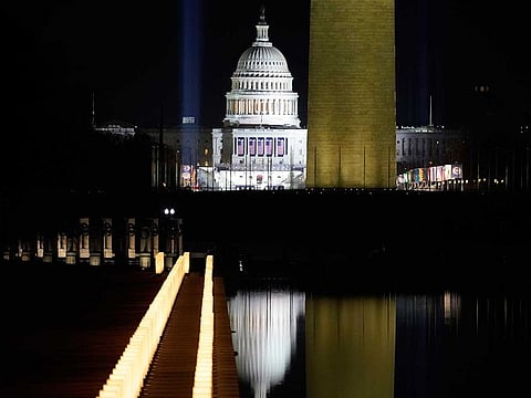 COVID-19 memorial lights surround the Reflecting Pool with the Washington Monument and the US Capitol in the background after the Celebrating America concert at the Lincoln Memorial in Washington