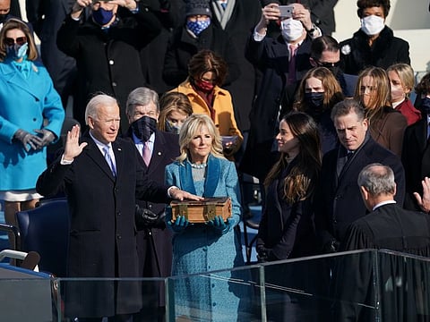Joe Biden is sworn in as the 46th President of the United States at the Capitol in Washington on Wednesday, Jan. 20, 2021, as his wife Jill Biden holds a bible.