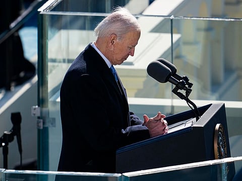 President Joe Biden pauses for a moment of silent prayer to remember those who died of COVID-19 during his inaugural speech at the Capitol in Washington on Wednesday, Jan. 20, 2021.
