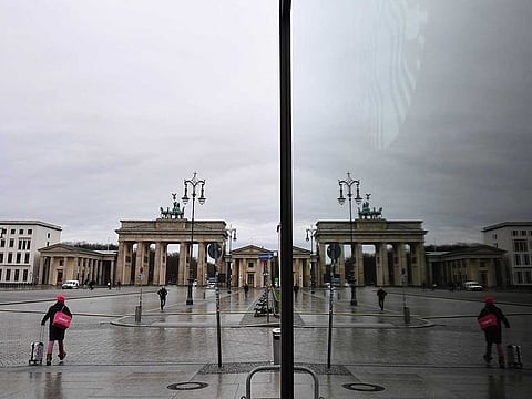 The near-empty Pariser Platz square in front of Berlin's landmark Brandenburg Gate (Brandenburger Tor) is reflected in a shop window on January 22, 2021, during the ongoing novel coronavirus (COVID-19) pandemic. Europe's top economy Germany this week extended its partial lockdown until February 14, 2021 and Chancellor Merkel has not ruled out border checks to slow the spread of the new strains.