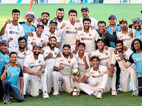 File photo: Indian players pose with the winning trophy after defeating Australia by three wickets on the final day of the fourth cricket test match at the Gabba, Brisbane, Australia.
