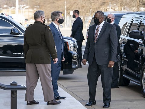 Mark Milley, Chairman of the Joint Chiefs of Staff, left, and John Kirby, Chief Pentagon Spokesman, greet incoming Secretary Of Defense Lloyd Austin III outside of the Pentagon on Austin's first day in his new role on January 22, 2021 in Arlington, Virginia.