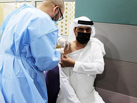 An Etisalat employee receives the vaccine.