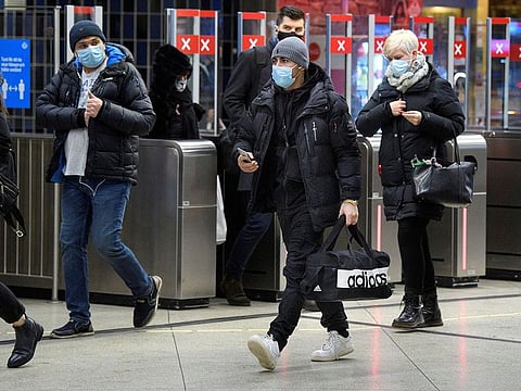 Passengers wearing protective masks enter an underground railway station, amid the spread of the coronavirus disease (COVID-19) pandemic, in Stockholm, Sweden, January 7, 2021.