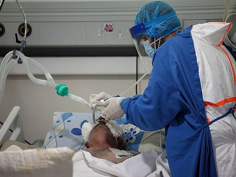 A medical staff member assists a patient suffering from the coronavirus disease (COVID-19), in an intensive care unit at Rafik Hariri University Hospital, in Beirut, Lebanon January 21, 2021. Picture taken January 21, 2021.