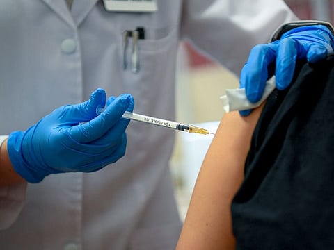 One of the dentist of the Clinical Center of the University of Debrecen Fruzsina Lilla Vojtko gets the second dose of Pfizer-Biontech's vaccine against the coronavirus by a health worker at the vaccination center of the Pulmonary Clinic in Debrecen, Hungary.