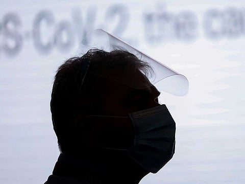 A man wearing a face mask and face shield