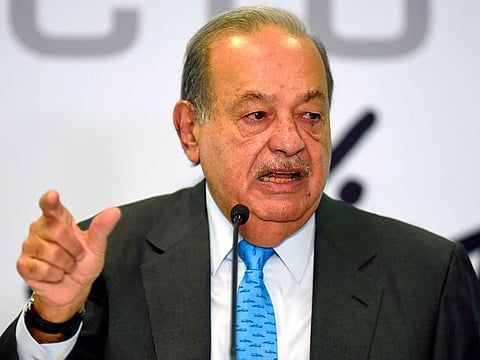 Mexican tycoon Carlos Slim gestures as he speaks during a press conference at the Inbursa office in Mexico City