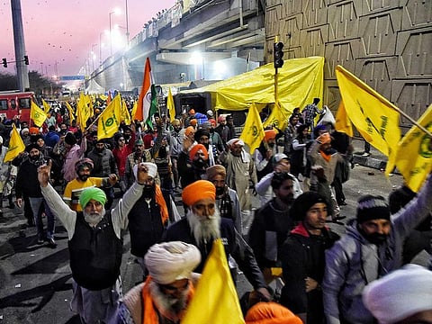 Farmers shout slogans during their ongoing protest against farm law, at Delhi-Ghazipur border in Delhi on Wednesday, January 27, 2021.