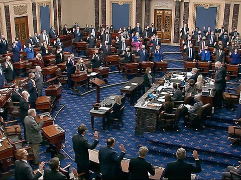 In this image from video, Sen. Patrick Leahy,  the president pro tempore of the Senate, who is presiding over the impeachment trial of former President Donald Trump, swears in members of the Senate for the impeachment trial at the US Capitol in Washington, Tuesday, Jan. 26, 2021.