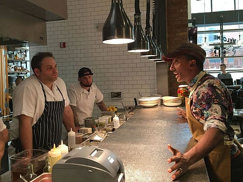 Marcus Samuelsson, right, talks to staff at his restaurant, Marcus B&P, in Newark, N.J.
