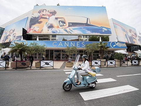 A scooter drives by the Palais des Festivals at the 71st international film festival, Cannes, southern France, on May 7, 2018.