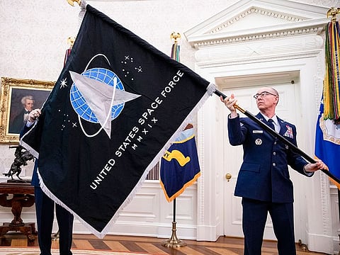 Gen. Jay Raymond, chief of space operations presents President Donald Trump with the official flag of the Space Force in the Oval Office at the White House in Washington, May 15, 2020.