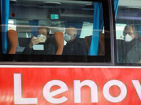 Members of the World Health Organisation (WHO) team tasked with investigating the origins of the coronavirus disease (COVID-19) pandemic sit on a bus before leaving Wuhan Tianhe International Airport in Wuhan, Hubei province, China January 14, 2021
