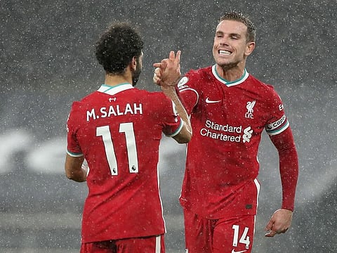 Liverpool's Jordan Henderson and Mohamed Salah celebrate after the match.