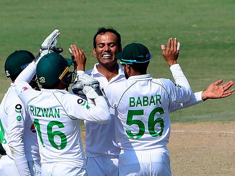 Pakistan's Nauman Ali celebrates with teammates after taking the wicket of South Africa's Anrich Nortje