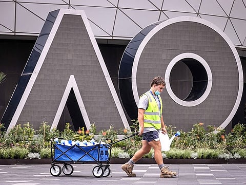 A worker wearing a face mask at the Australian Open venue in Melbourne. The world's top tennis stars emerge from two weeks stuck in their hotel rooms due to quarantine imposed upon their arrival ahead of the Australian Open