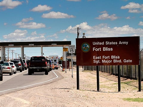 Fle photo: Cshows cars wait to enter Fort Bliss in El Paso, Texas.