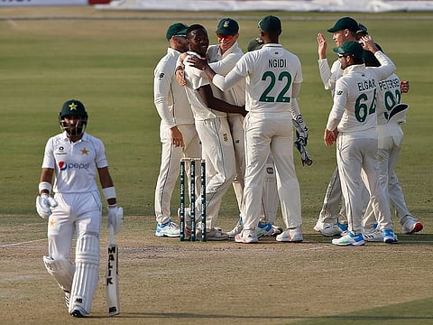 South Africa pacer Kagiso Rabada celebrates with teammates after taking the wicket of Pakistan batsman Imran Butt