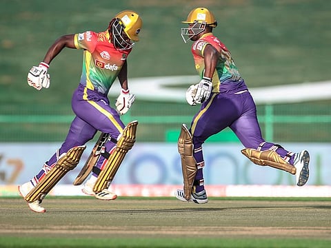 Bangla Tigers captain Andre Fletcher (left) and Jonathon Charles cross over for a single during their chase at the Abu Dhabi T10 on Saturday.