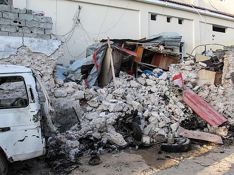 Debris remain at the blast site from a suicide car bombing attack at the side of Afrik Hotel in Mogadishu.