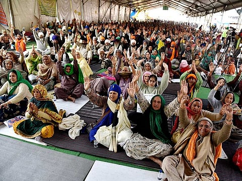 Farmers shout slogans at the site during their ongoing protest against farm laws at Singhu border, in Delhi on Tuesday, February 2, 2021.