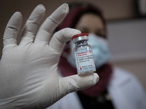 A Palestinian medic displays a vial of the Moderna COVID-19 vaccine, at the health ministry, in the West Bank city of Bethlehem.