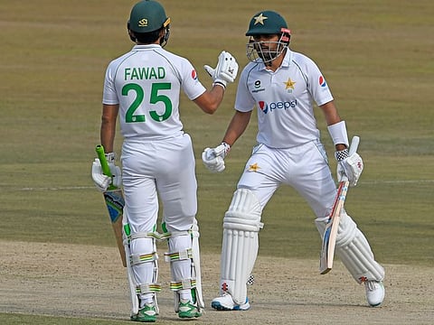 Pakistan captain Babar Azam (right) is greeted by Fawad Alam on reaching his half-century on the first day of the second Test against South Africa in Rawalpindi on Thursday.