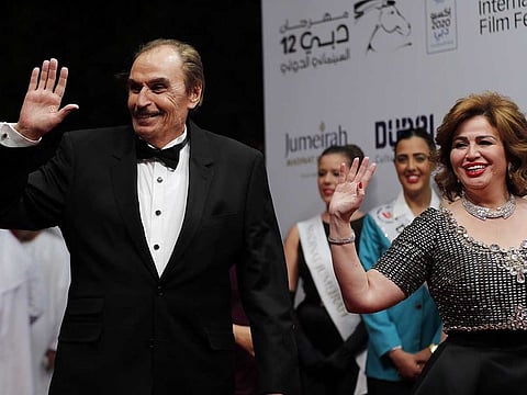In this file photo taken on December 9, 2015, Egyptian actors Ezzat El Alaili (L) and Elham Chahine pose for photographers at the opening ceremony of the annual Dubai International Film Festival. Veteran Egyptian actor Ezzat El Alaili died at the age of 86 on February 5, 2021.