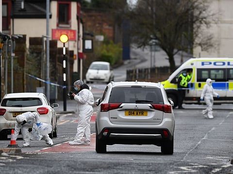 Police forensics officers work at the scene of a fatal stabbing in Portland Street, Kilmarnock, in west Scotland, on February 5, 2021.
