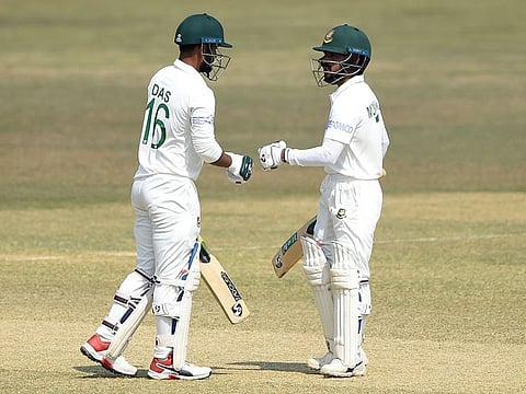 Bangladesh's Liton Das with his captain Mominul Haque during the fourth day of the first cricket Test match between against West Indies