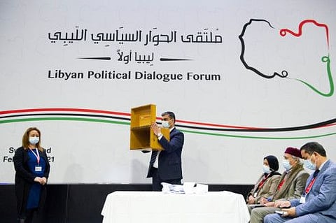 A staff shows the empty ballot box after delegates voted for the election of a new interim government for Libya during the Libyan Political Dialogue Forum in Chavannes-de-Bogis near Geneva, Switzerland, February 5.