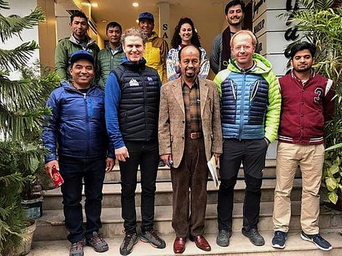 In this January 8, 2020, photo provided by Alpine Club of Pakistan, Iceland's mountaineer John Snorri, second left in front row, and his team members pose for photograph with Karrar Haider, a top official of Alpine Club of Pakistan, centre in front row, after a meeting, in Islamabad. An aerial search mission is on to find three experienced climbers, Ali Sadpara and his two companions, John Snorri and Juan Pablo Mohr, who lost contact with the base camp during their ascend on world's second top peak in northern Pakistan, official said Sunday.