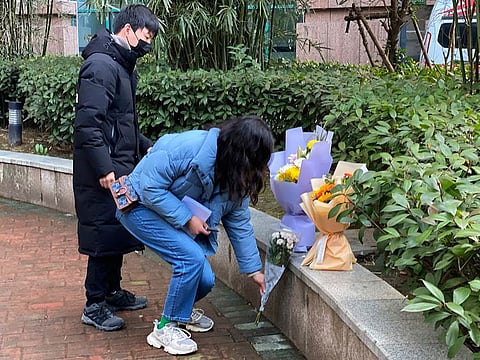 Residents visiting the Wuhan Central Hospital offer flowers in memory of Li Wenliang, the whistleblower doctor who sounded the alarm and was reprimanded by local police for it in the early days of Wuhan's pandemic, prior to the anniversary of his death, in central China's Hubei province.