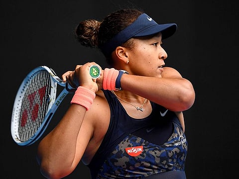 Japan's Naomi Osaka hits a return against Russia's Anastasia Pavlyuchenkova during their Australian Open tennis tournament in Melbourne on February 8, 2021.