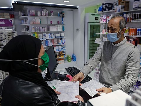 A woman buys medicine at a pharmacy in the Lebanese capital, Beirut, on February 2, 2021.