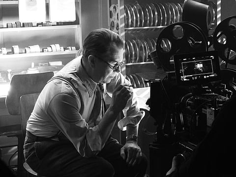 In this image released by Netflix, Gary Oldman portrays Herman Mankiewicz in a scene from "Mank."