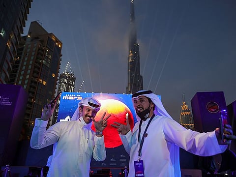 Emirati men pose as they attend an event to mark the Hope Probe's entering the orbit of Mars at Burj Plaza in Dubai on February 9. File photo