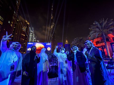 Emiratis celebrating the success of UAE's Hope Probe at Burj Plaza in Dubai on Tuesday.