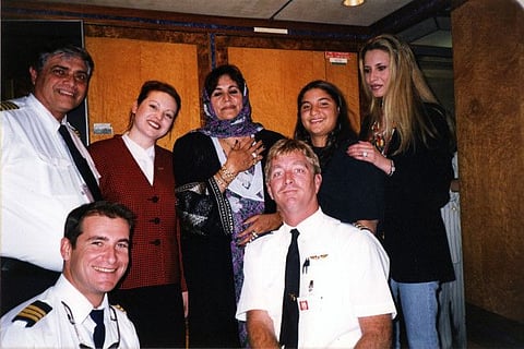 A reproduction of an undated file photo found in a family album at Gaddafi's former headquarters in Tripoli's Bab Al Aziziya compound on August 28, 2011 shows his daughter Aisha (right) and her mother Safiya (centre) with an unidentified plane crew.