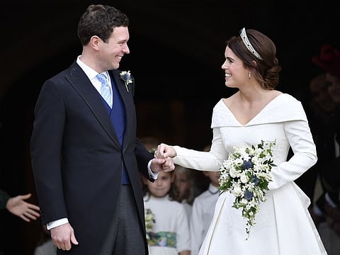 In this Friday Oct. 12, 2018 file photo, Britain's Princess Eugenie and Jack Brooksbank leave St George's Chapel after their wedding at Windsor Castle, near London, England.