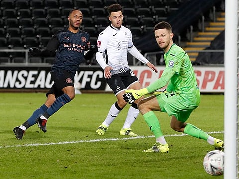 Manchester City's Raheem Sterling scores their second goal.
