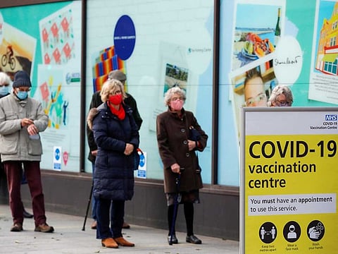 People queue to receive the coronavirus disease (COVID-19) vaccine outside a store that is being used as a vaccination centre in Folkestone, Kent, Britain January 28, 2021.