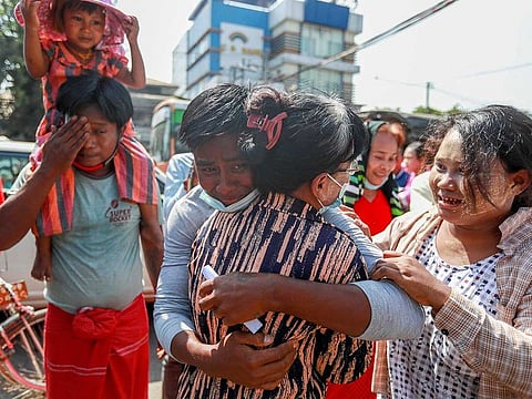 A released prisoner hugs a family member outside the Insein prison in Yangon, Myanmar Friday, Feb. 12, 2021.