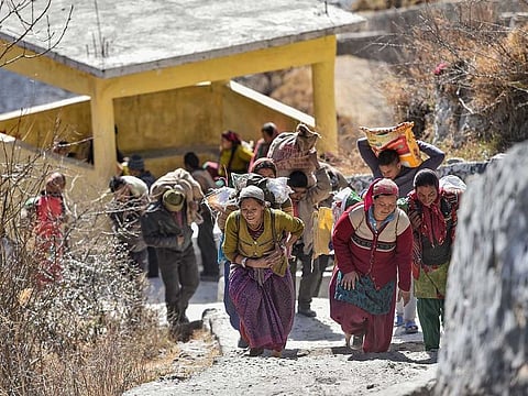 Flood-affected villagers of Bhalla gaon after receiving relief material from authorities, in Chamoli district of Uttarakhand, Friday, Feb. 12, 2021.