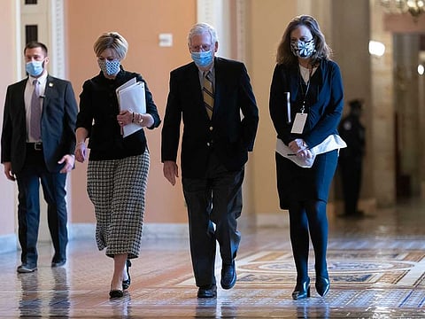 Senate Minority Leader Mitch McConnell, R-Ky., returns to the chamber after the Senate voted to consider hearing from witnesses in the impeachment trial of former President Donald Trump, at the Capitol in Washington, Saturday, Feb. 13, 2021.