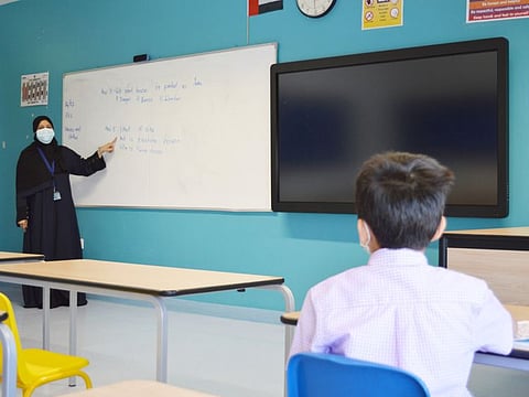 A teacher and student at a school in Abu Dhabi yesterday.