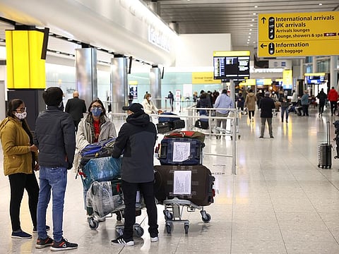 Travellers walk through Terminal 2 at Heathrow Airport, amid the COVID-19 outbreak in London.