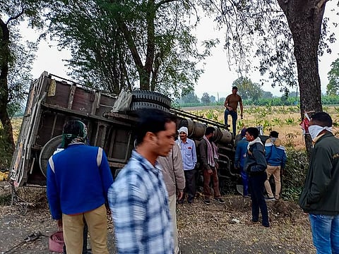 People gather near the mangled remains of a truck after it overturned near Kingaon village, killing atleast 16 labourers, in Jalgaon district of Maharashtra.