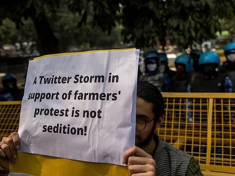 A demonstrator holds a placard during a protest against the arrest of 22-year-old climate activist Disha Ravi,  outside the police headquarters in New Delhi, India, February 16, 2021